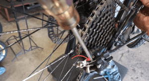 adjust the low limit screw until the upper pulley is in line with the largest cog of the cassette.