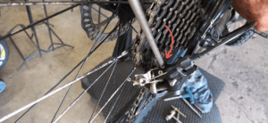Adjust the high limit screw by making sure that the upper pulley is in line with the smallest cog.
