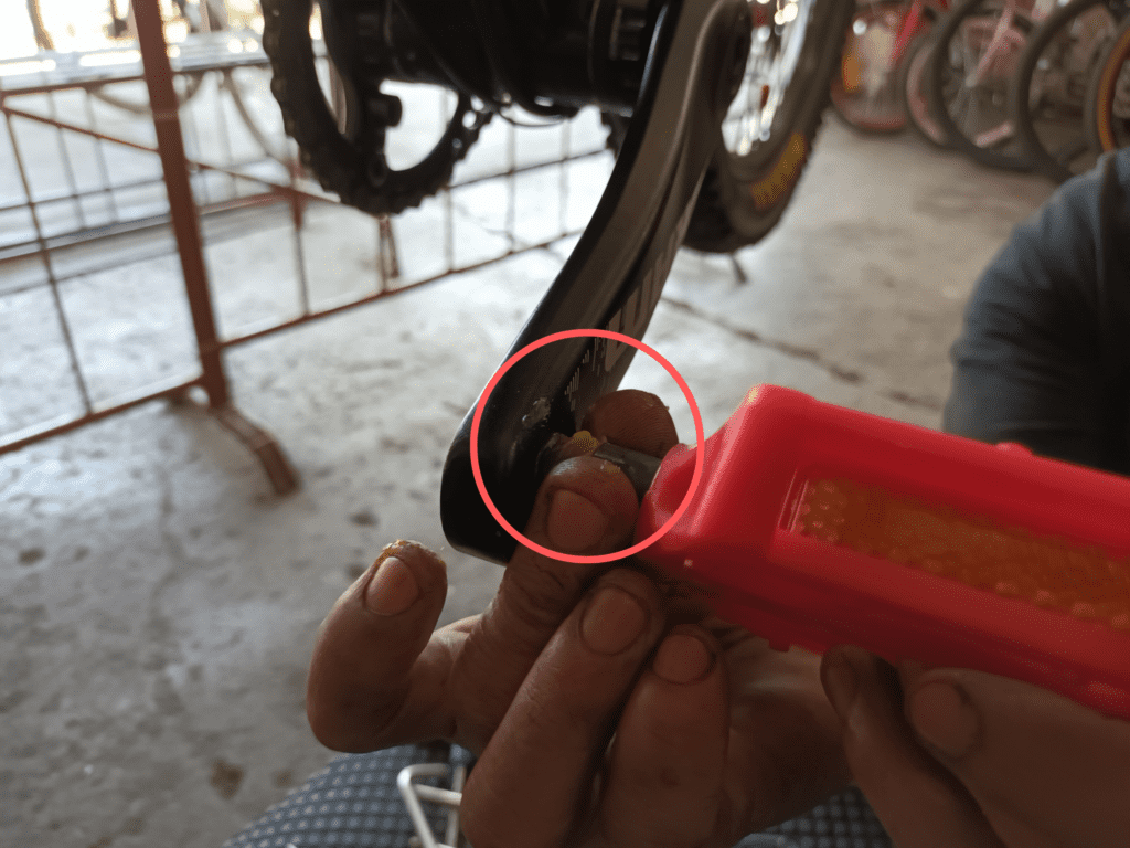 Use your fingers to thread the right pedal onto the crank while holding the hex wrench part.